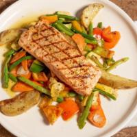 Salmone · Marinated and grilled Norwegian salmon served over a bed of fresh roast potatoes topped with...