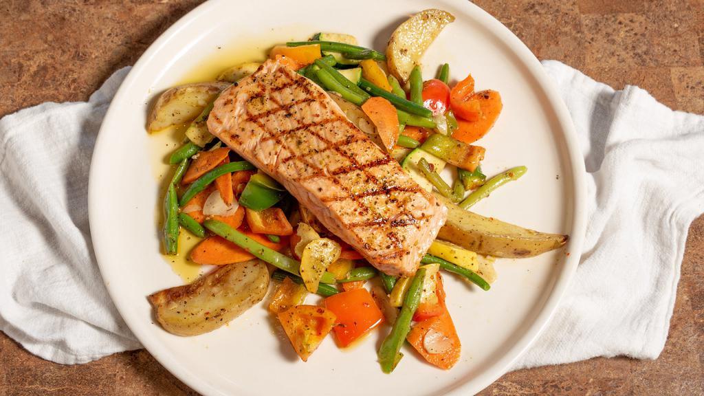 Salmone · Marinated and grilled Norwegian salmon served over a bed of fresh roast potatoes topped with grilled vegetables.