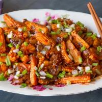Baby Corn Manchuria · Deep-fried baby corn sauteed with sweet and hot chilli sauce.