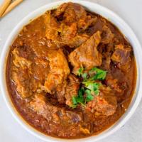 Goat / Lamb Vindaloo · Diced goat/lamb cooked in potatoes and house special sauce.