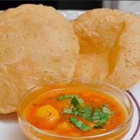 Amitabh Aloo Puri · Puffed wheat bread deep fried and served with potato curry.