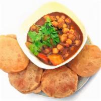 Chole Puri · Puffed wheat bread deep fried and served with chickpeas curry.