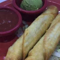 Flautas · Two flour tortillas stuffed and rolled with shredded beef or chicken, then fried. Served wit...
