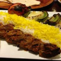 Shish Kabob · Marinated pieces of lamb leg, skewered w/ fresh bell pepper, onion, and tomato, grilled on o...