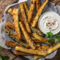 Fried Zucchini · Zucchini sticks coated in seasoned breadcrumbs and deep fried to golden brown.