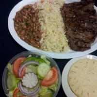 Carne Asada · Grilled steak grilled steak. Served with rice, beans, salad and tortillas.