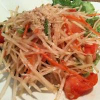 Papaya Salad · Shredded green papaya, sun-dried shrimp mixed with tomatoes, and string beans in spicy lime ...