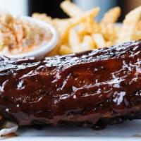 1/2 Rack Baby Back Ribs · slow roasted and then grilled with BBQ sauce. Served with cornbread, fries and Cole slaw.