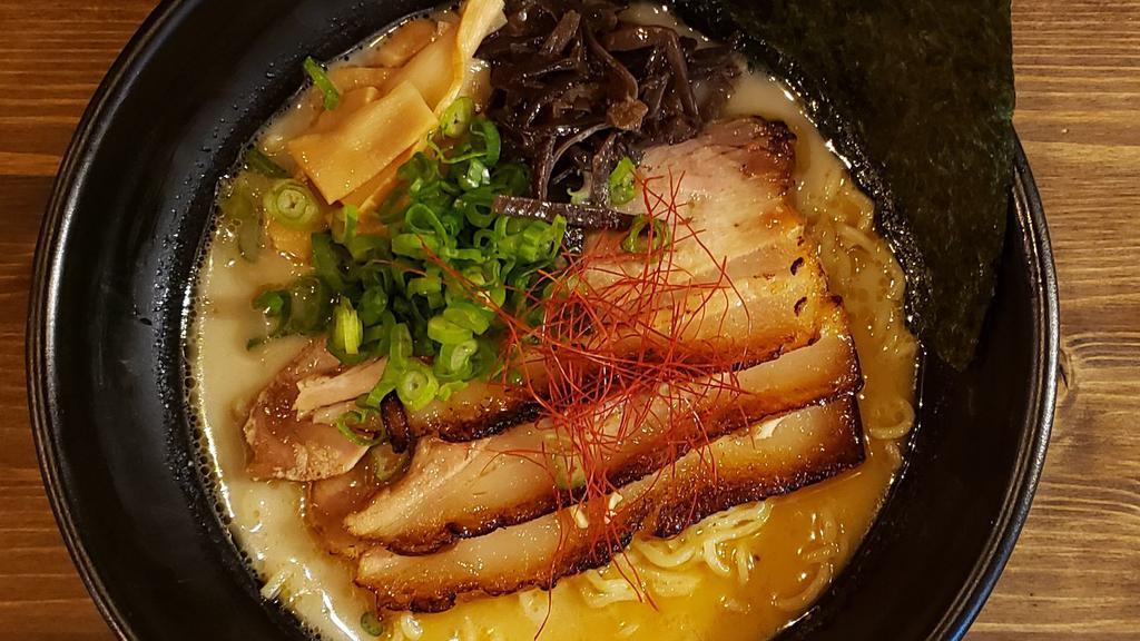 Tonkotsu Ramen · Contains dairy and egg. Pork broth, cha-shu pork (marinated braised pork belly), nori, menma (Japanese bamboo), wood ear mushrooms, shredded red pepper, scallions and black garlic oil.
