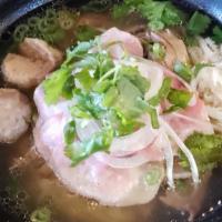 Dac Biet · Famous Vietnamese beef noodle soup with rare steak, well done flank, tripe, and beef ball in...