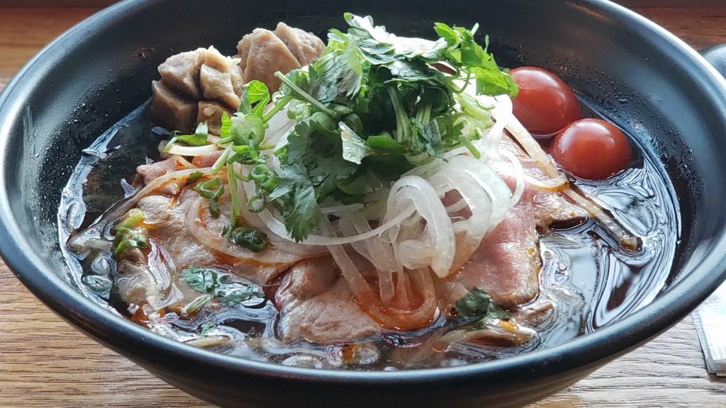 Pho Sate · Spicy beef noodle soup combined with slice rare steak, well done flank, beef ball, and tomato in spicy chili oil beef broth. Served with fresh bean sprouts, basil leaves and lime wedges.