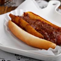 Texas Rodeo Dog · Bacon-wrapped beef hot dog topped with onion rings and factory chili.