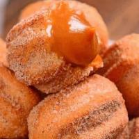 Mini Churros Box 100 · Fried Sweet Dough filled with Dulce de Leche and Dusted with Cinnamon and Sugar.