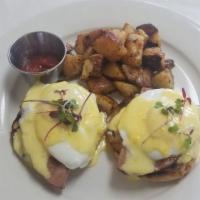 Classic Benedict · Two English muffins topped with smoked ham, two poached eggs and house made hollandaise sauc...