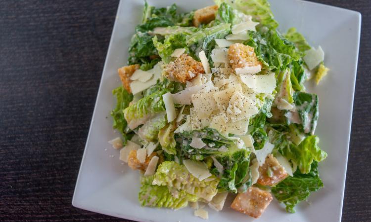 Side Caesar Salad · Crisp romaine lettuce with croutons, parmesan cheese and caesar dressing.