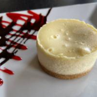 Cheesecake · Creamy vanilla cheesecake sitting on a traditional buttery graham cracker crust.