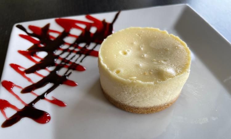 Cheesecake · Creamy vanilla cheesecake sitting on a traditional buttery graham cracker crust.