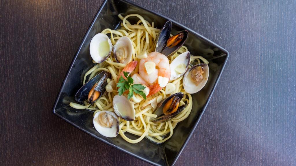 Feast Of The Sea · A combination of sauteed shrimp, mussels and clams served with pasta, garlic bread, and choice of soup or salad.