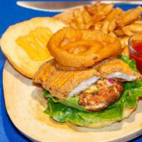 The Trice · Crab cake sandwich w/ cajun remoulade, lettuce, roasted mango pico de gallo, topped w/ an on...
