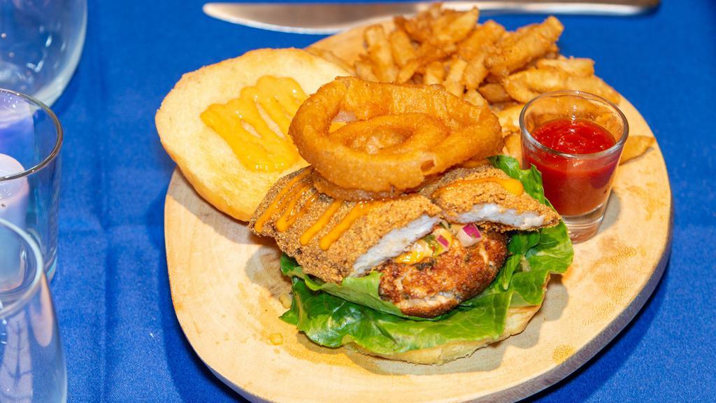 The Trice · Crab cake sandwich w/ cajun remoulade, lettuce, roasted mango pico de gallo, topped w/ an onion ring & crispy catfish on a brioche bun. Served w/ fries.