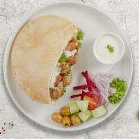 Chicken Out Pita · Grilled chicken with red onions, tomatoes, and tzatziki sauce in a grilled Greek pita.