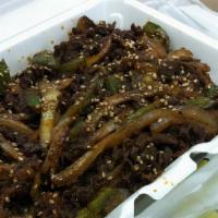 Bulgogi & Rice · Rib eye steak, green peppers, fried onions, soy sauce, sesame oil, salad.