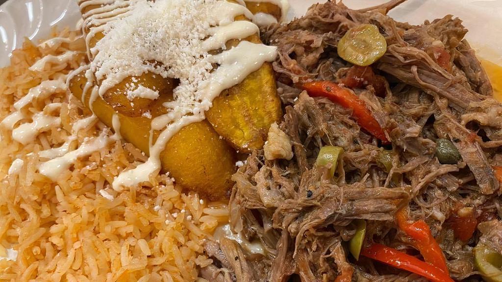 La Ropa Vieja · Braised Beef with Tomatoes, Onions, Sweet Peppers, Cilantro, Capers & Olives.  Served with Mexican Rice and Sweet Plantains.
