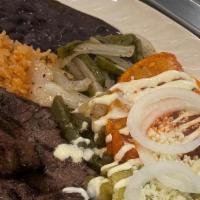 La Tampiqueña · Grilled Ribeye Steak, Served with Black Beans, Rice, Sautéed Cactus Onions and Two Enchilada...