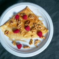Vermont Berry · Crepe filled with maple raspberry cream cheese, topped with syrup, walnuts, and fresh raspbe...