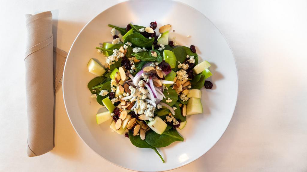 La Familia Salad · Gluten Conscious. Baby spinach with dried cranberries, sliced almonds, green apples, red onions & crumbled blue cheese. Served with our homemade vinaigrette dressing.