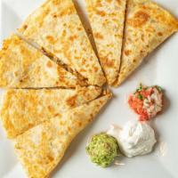 Quesadillas · Flour tortilla stuffed with cheese and choice of steak or grilled chicken with guacamole, so...