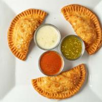 Empanadas · Stuffed corn pastry with choice of beef or chicken.