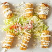 Flautas · Three crispy corn taquitos stuffed with chicken tinga drizzled with sour cream, lettuce and ...