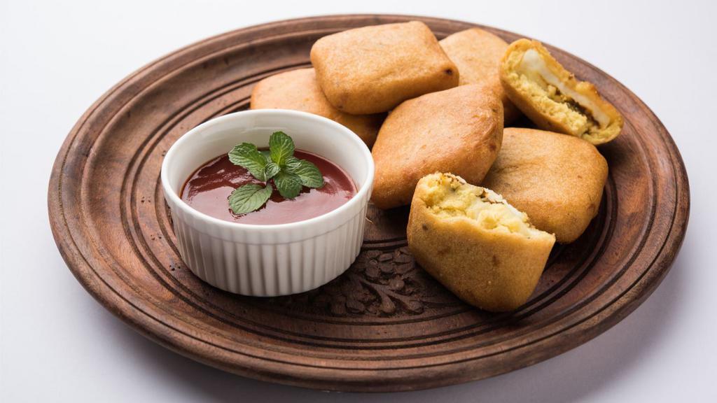 Paneer Pakora · Freshly prepared battered cottage cheese snack, dipped in flour batter, mixed Indian spices and deep fried to perfection.