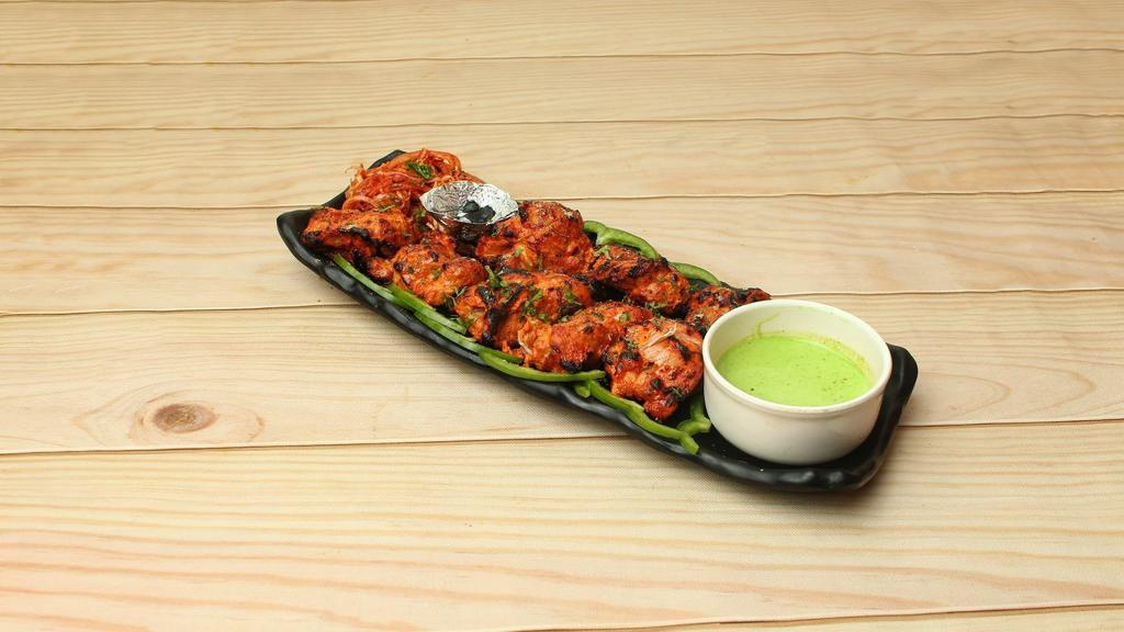 Salmon Fish Tikka · Freshly prepared tender chunks of  salmon marinated in yogurt, Indian herbs and spices. Further BBQ in a tandoor clay oven.