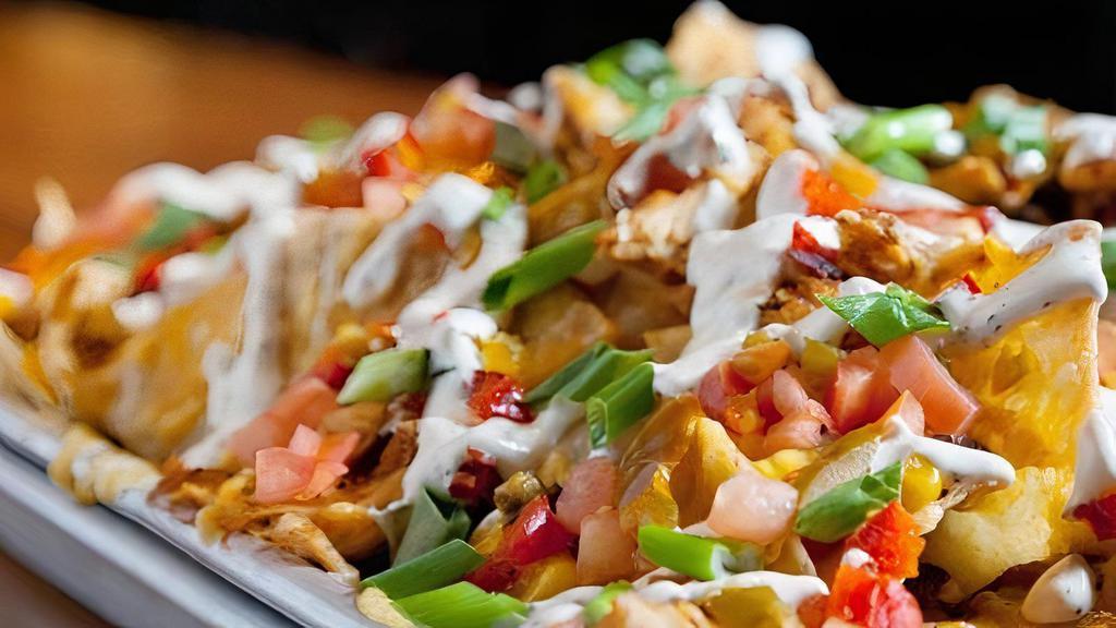 Rht Nachos · House-fried Mayan white corn tortilla chips, cheddar jack cheese, diced tomatoes, cherry peppers, grilled corn & black bean salsa, scallions, RHT sour cream.