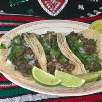 Tacos · Three corn tacos, cilantro, onions, and lemon and green sauce on the side. Meat must be added.