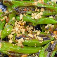 Thai Style Shishito Peppers · Blistered with olive oil, sea salt, lime in Szechuan sauce served over peanut sauce and crun...