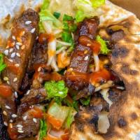 Korean Short Rib Taco (1 Taco) · BBQ short ribs, sweet Asian slaw, toasted sesame seeds, sriracha agave, flour tortilla. Serv...