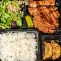 Chicken Katsu Bento · Panko breaded chicken cutlet with steam rice, 2 pcs of fried gyoza, salad, and miso soup.