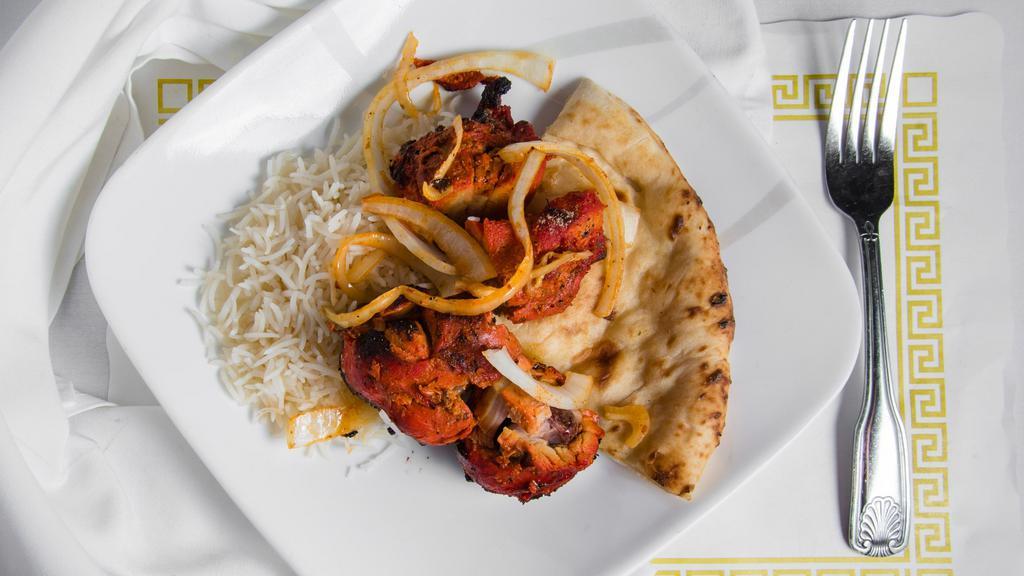 Tandoori Chicken · Chicken with bone marinated & spiced overnight, broiled in clay oven.