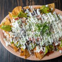 Nachos Matador · Gluten free. Fresh, house made corn tortilla chips, topped with melted cheese, refried beans...