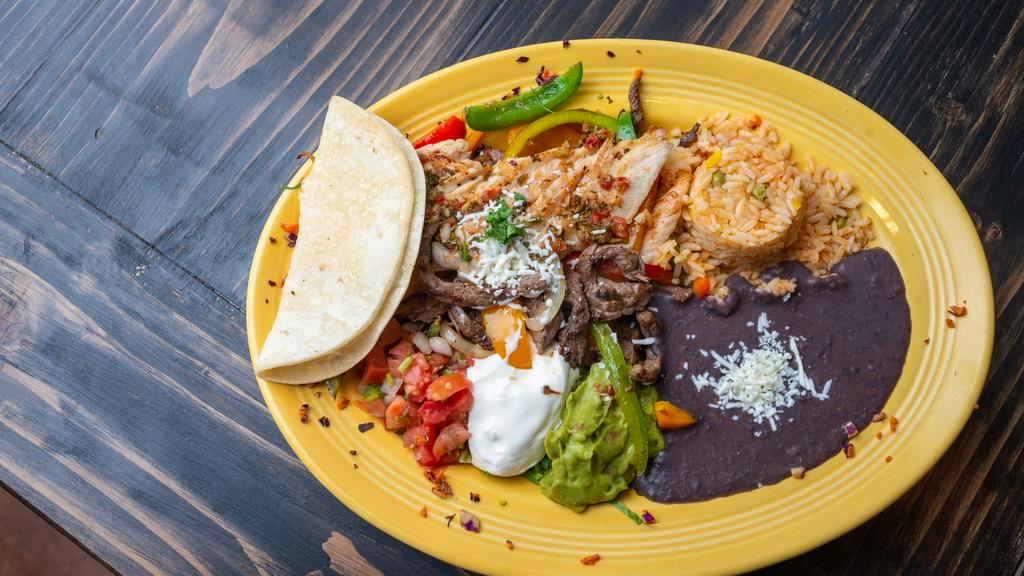 Fajitas Toro · Served with grilled onions, bell, jalapeño, or mixed peppers, a cheese quesadilla, traditional rice, refried beans, guacamole, pico de gallo, sour cream and warm corn or flour tortillas on the side.