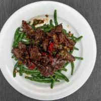Yuen Yang Spicy Beef K 岳阳牛 K · In a hot pepper sauce, served on a bed of string bean. Spicy.