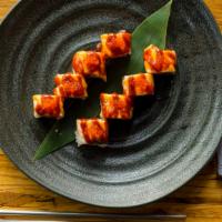 Volcano Maki · Eight pieces. Crabmeat and avocado wrapped with grilled salmon, tobiko, spicy mayonnaise, an...