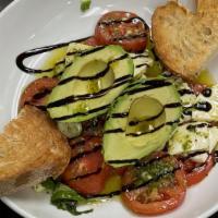 Caprese Stuffed Avocados · Cherry tomato, fresh Mozzarella, pesto and balsamic.