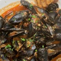 Mussels · New Zealand green-lipped mussels with a choice of spicy marinara sauce or lemon butter and w...