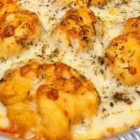 Flying Saucers · Deep fried pizza dough tossed in garlic butter with pizza sauce and grated parm