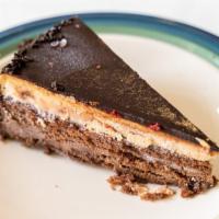 Chocolate Temptation Cake · Chocolate cake filled with chocolate cream,
hazelnut cream and hazelnut crunch, finished wit...