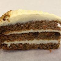 Carrot Cake · With real cream cheese, sliced walnuts and golden raisins